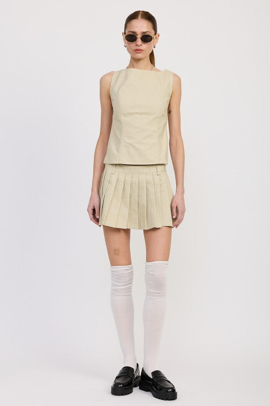 Emory Park Rider Mini Skort in Natural pleated design worn with sleeveless top and knee-high socks