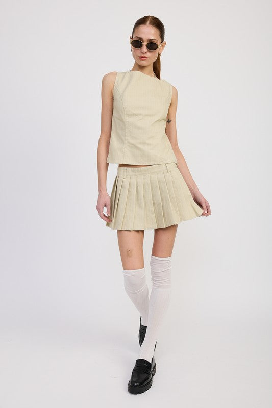 Emory Park Rider Mini Skort in beige worn with sleeveless top, white knee-high socks, and black loafers