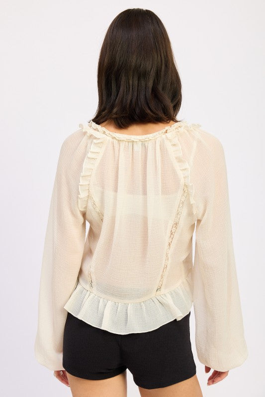 Back view of Emory Park Round Neck Long Sleeve Flared Blouse with ruffle details and sheer fabric