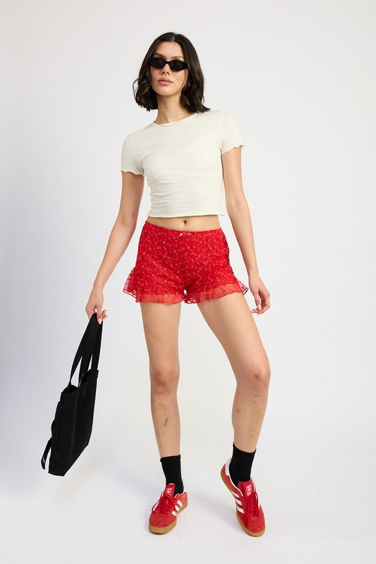 Emory Park Ruffle Jersey Shorts in red worn with white crop top and red sneakers