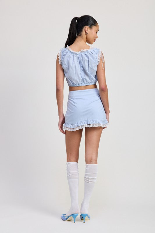 Emory Park model wearing a light blue Ruffled Mini Skirt With Lace Detail paired with matching top and white knee-high socks