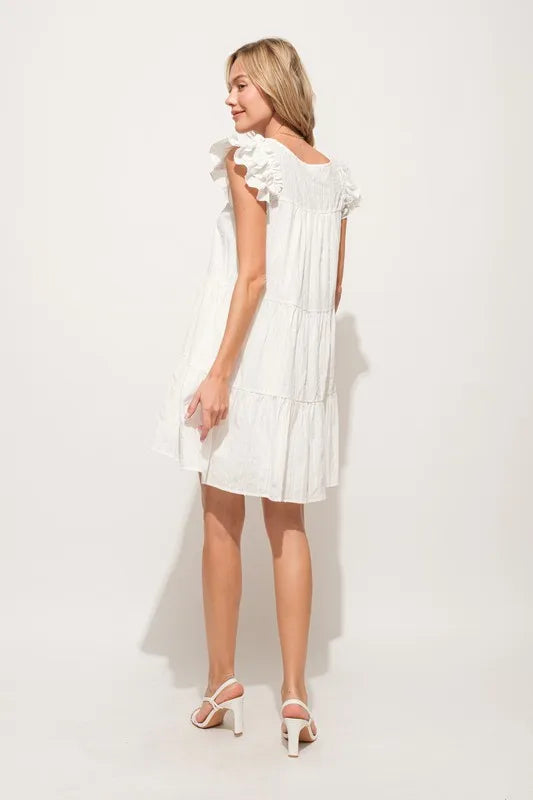 Back view of a stylish Ruffled Sleeve Tiered Dress in white, perfect for summer outings