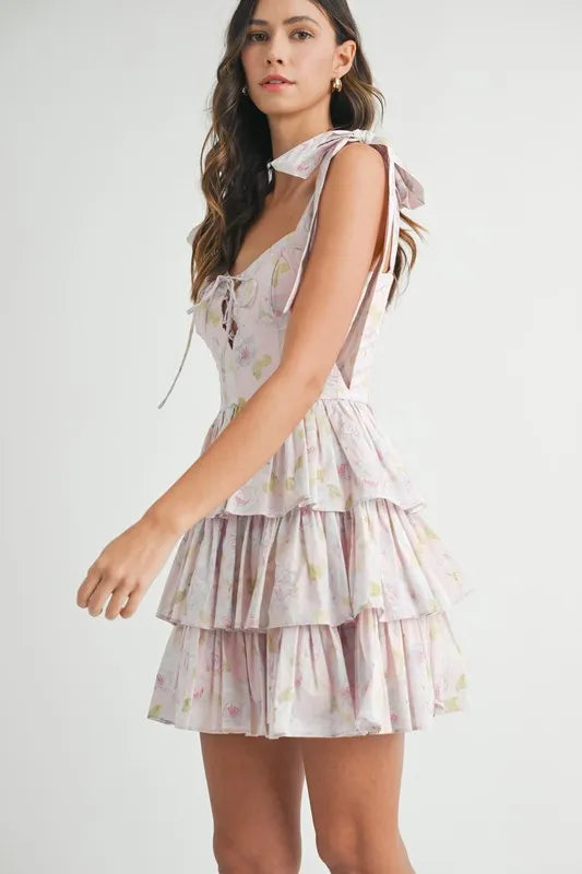 Shoulder tie mini dress with ruffled tiers and floral pattern for a feminine look