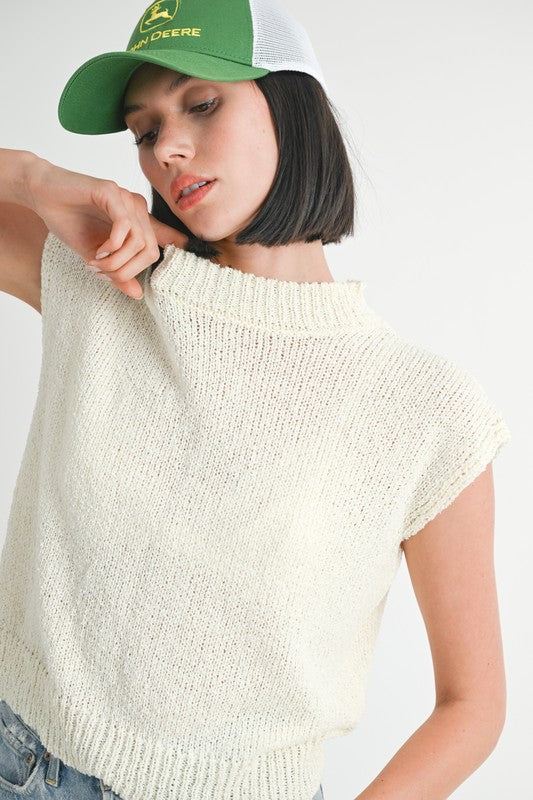 Emory Park cream sleeveless sweater top worn by woman with green John Deere cap