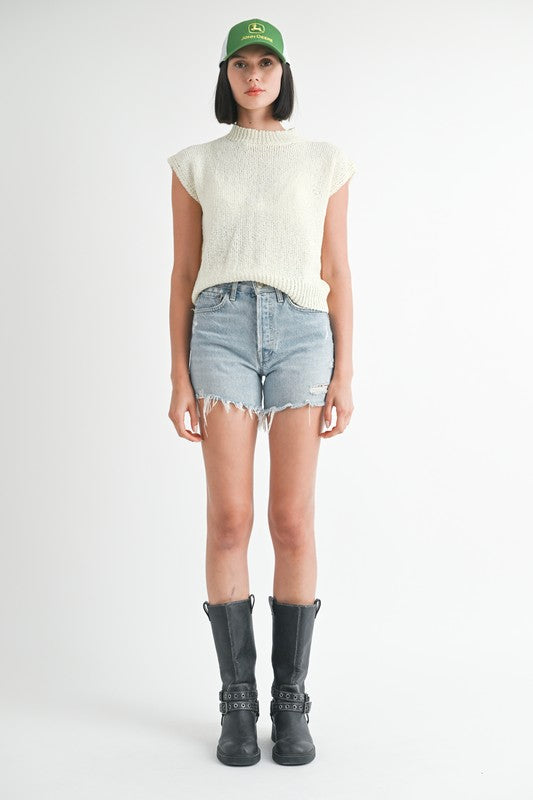 Emory Park sleeveless sweater top in cream worn with denim shorts and black boots