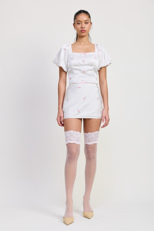Emory Park Square Neck Bubble Cap Sleeve Top in white with floral pattern styled with matching skirt and lace thigh highs