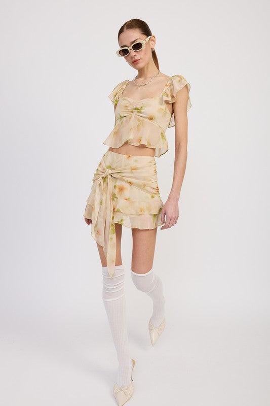 Emory Park squared neck top with cap sleeves in floral print paired with matching skirt and white knee-high socks pose