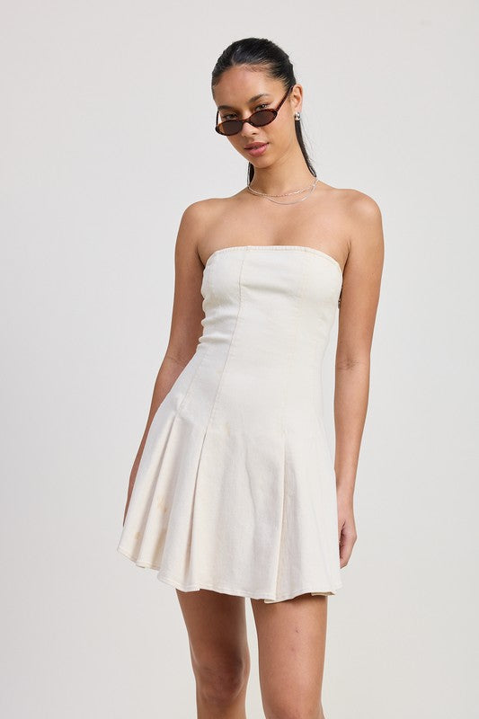Emory Park strapless mini ruffle dress in white worn by model with sunglasses and necklace
