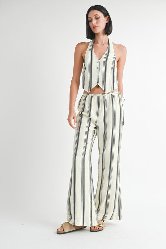 Emory Park striped straight leg pants in white with black vertical stripes worn with matching halter top