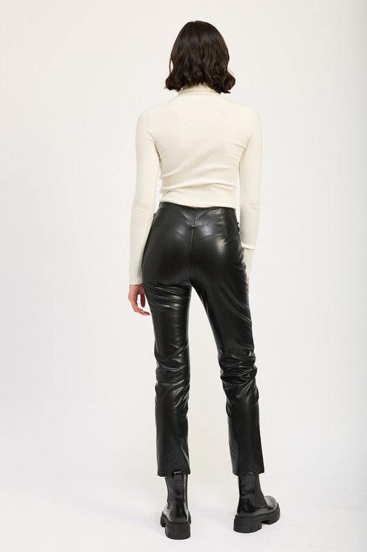Lace-Up Leather Trousers high waisted black leather back view on model paired with cream top and boots