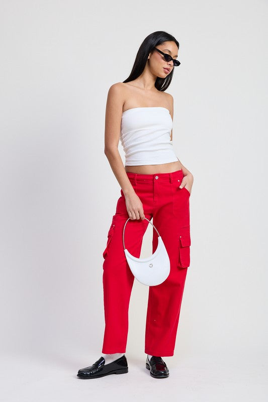 Model wearing Emory Park red Pocket Cargo Pants with white tube top black loafers and white crescent bag
