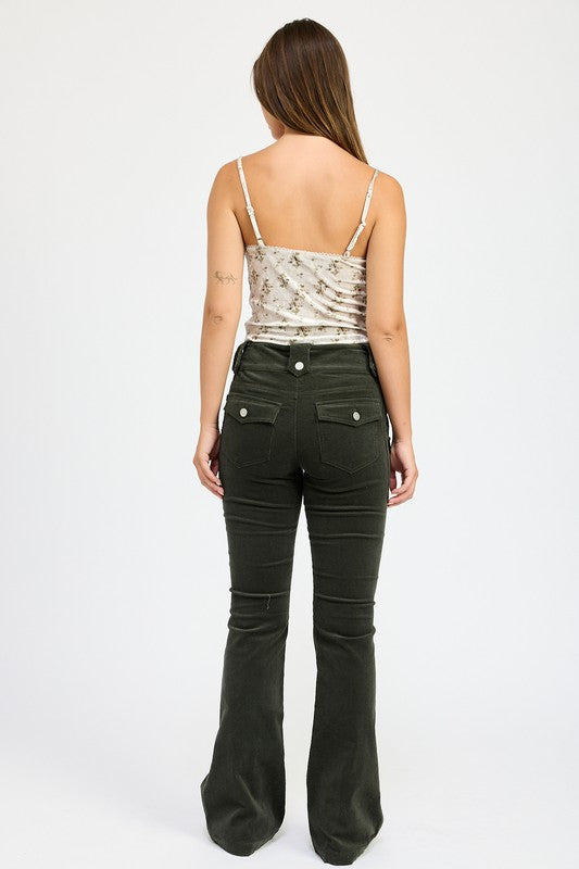 Back view of a woman wearing Emory Park Velvet Ruched Top With Lace Detail and black fitted pants