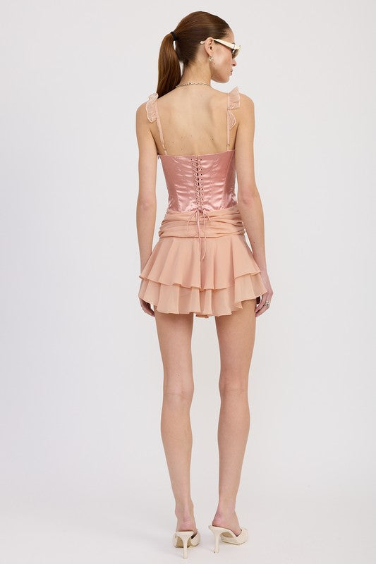 Back view of Emory Park contrasted mini corset dress with ruffle detail in blush pink on model