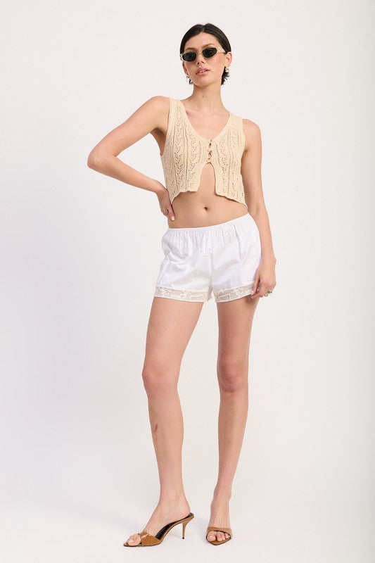 Emory Park Crochet Button Front Vest Top in beige worn with white shorts and sunglasses hand hip pose