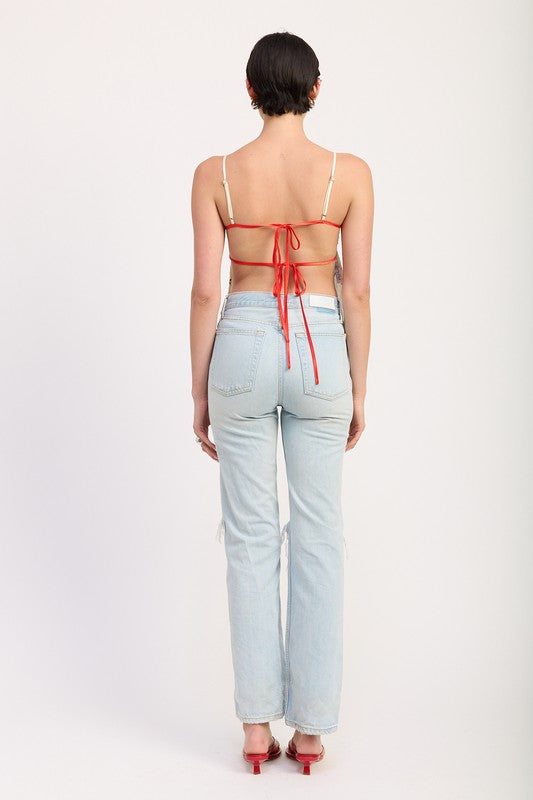 Back view of model wearing Emory Park Floral Sweetheart Cami Top with exposed back and tie details