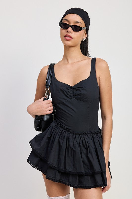 Emory Park Mini Asymmetrical Sleeveless Dress in black with ruched bodice and layered skirt detail