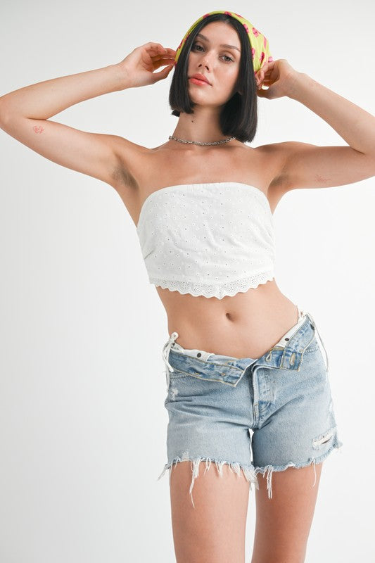 Emory Park Cropped Eyelet Tube Top in white worn with distressed denim shorts