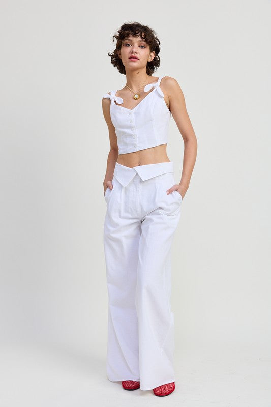 Emory Park Button Up Cropped Top With Shoulder Ties in white worn with high-waisted white pants