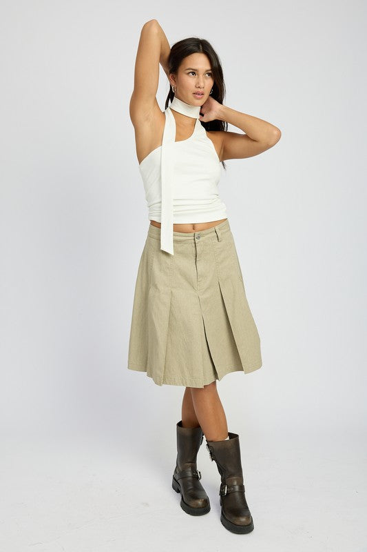 Emory Park Knee Length Pleated Skirt in khaki worn with white top and black boots