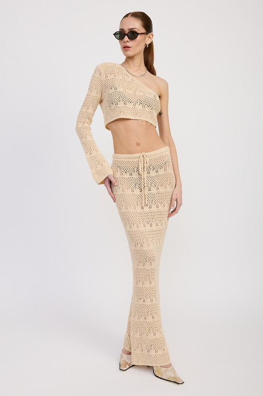 Woman wearing beige Crochet Maxi Skirt With Waist Drawstrings and one-shoulder crochet top with sunglasses by Emory Park