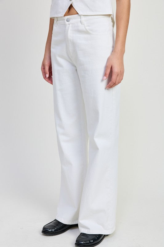 Emory Park white folded fitted denim pants worn with black shoes and a white top