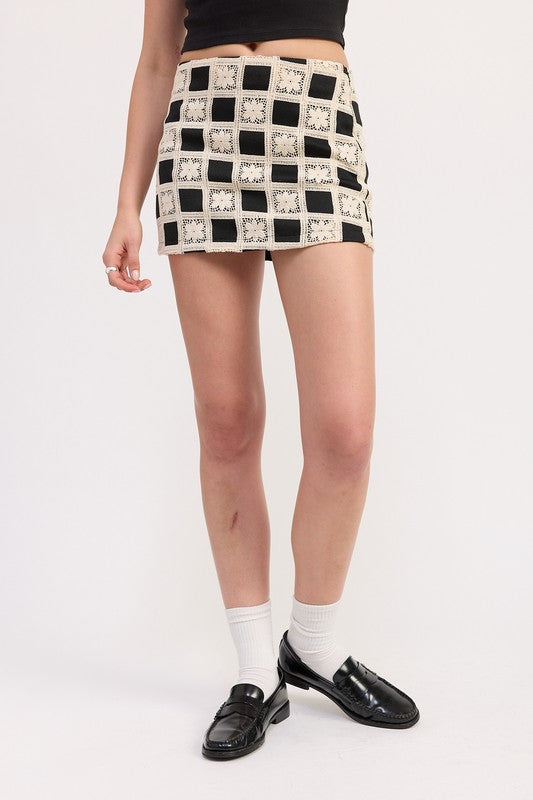 Emory Park Mini Jacquard Skirt featuring black and cream checkered pattern worn with black loafers and white socks