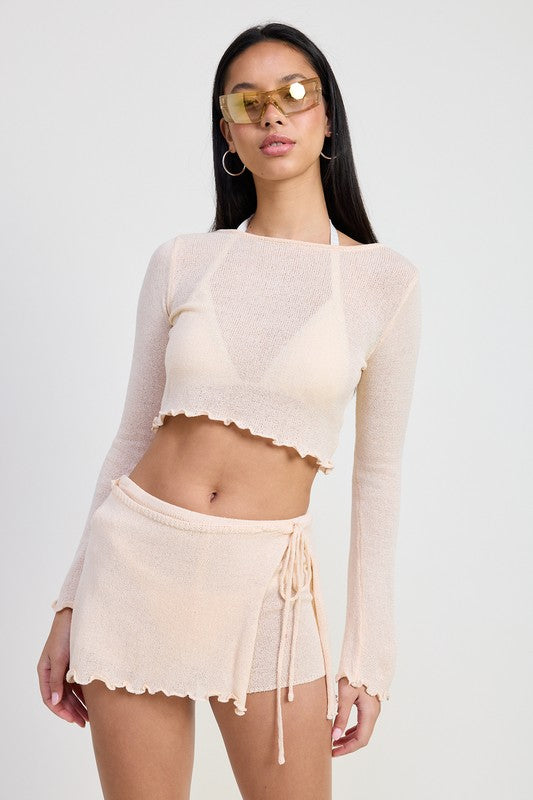Emory Park long sleeve boat neck cropped top in light beige worn with matching skirt and sunglasses
