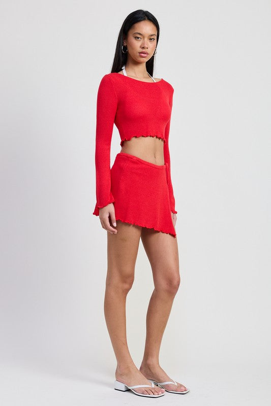 Emory Park red Long Sleeve Boat Neck Cropped Top paired with matching red skirt on female model