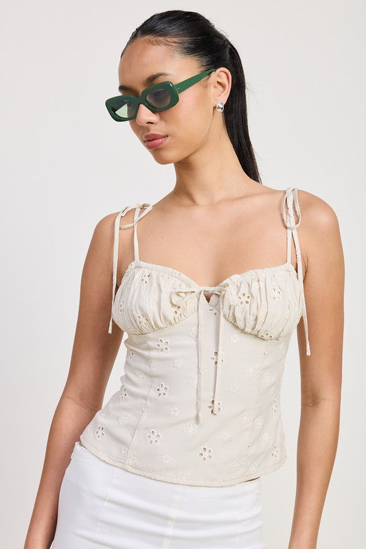 Emory Park Bustier Top With Shoulder Ties in cream eyelet fabric worn by model with green sunglasses