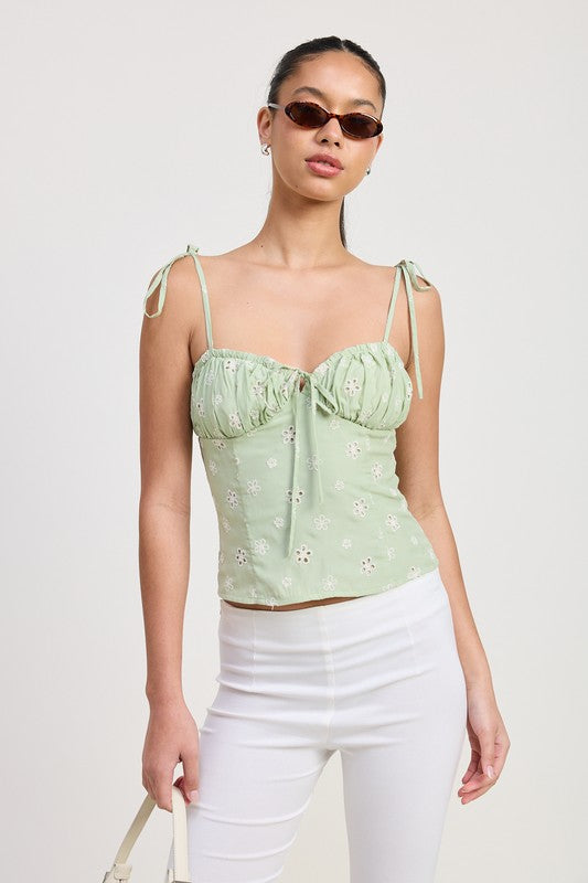 Emory Park light green Bustier Top With Shoulder Ties worn by model with white pants and sunglasses
