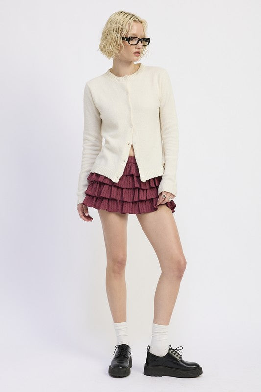 Emory Park Fitted Button-Up Cardigan in cream, styled with a ruffled skirt for a trendy outfit