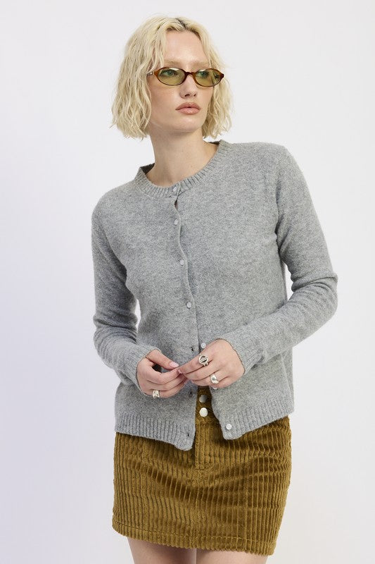 Emory Park Fitted Button-Up Cardigan in soft gray, paired with a corduroy skirt and stylish sunglasses