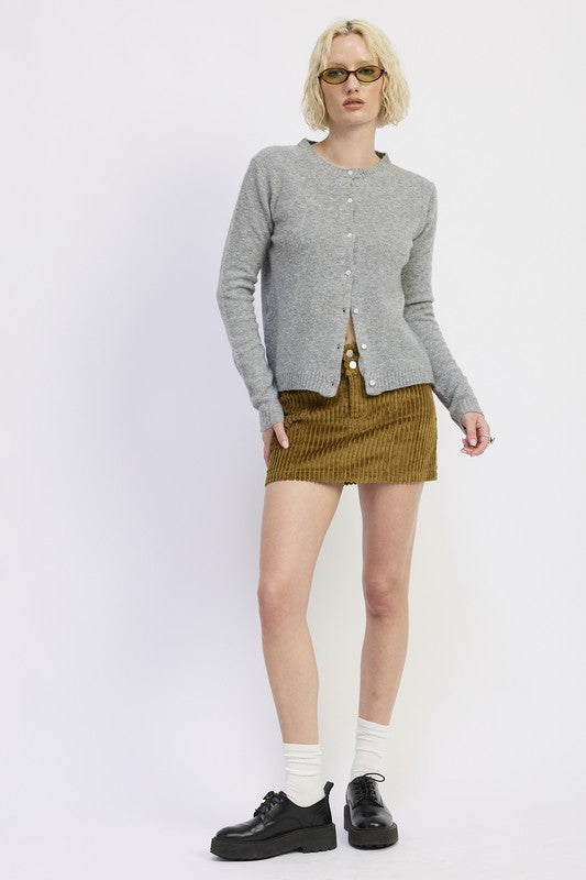 Light gray Fitted Button-Up Cardigan paired with a corduroy skirt and stylish black shoes