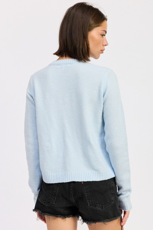 Light blue fitted button-up cardigan by Emory Park, perfect for layering over casual outfits