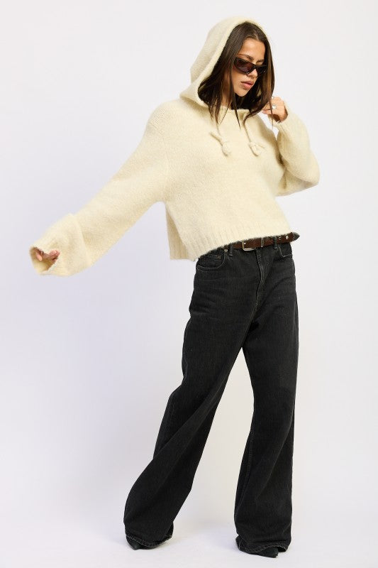 Emory Park Fringe Hoodie With Drawstrings in ivory, styled with loose black pants and sunglasses