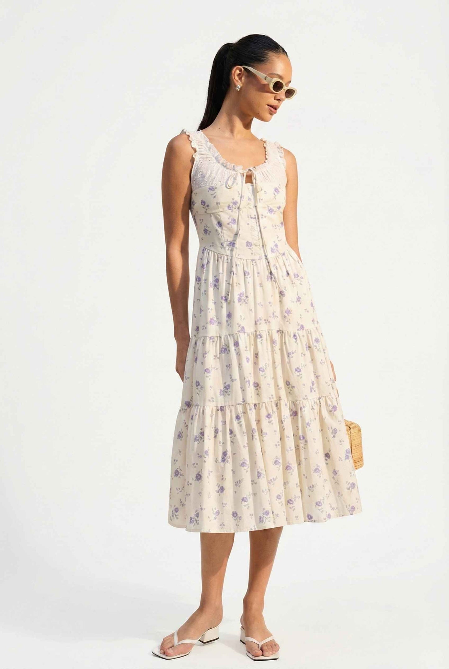 Woman wearing a Adeline Midi | Ivory Floral Eyelet Tiered Dress on a white background