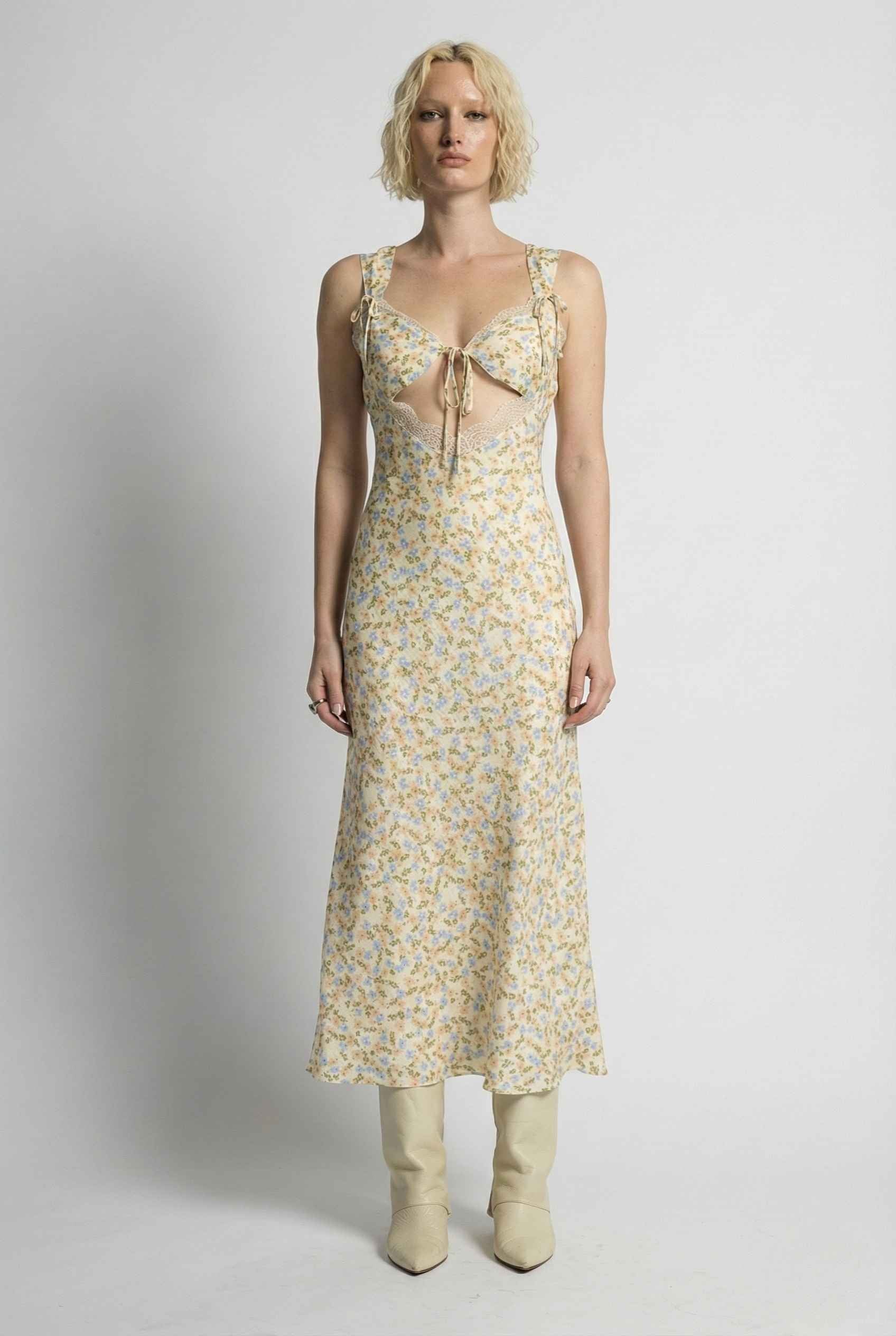 Woman wearing a Amelie Midi Cutout Yellow Floral Rayon Blend Dress with a plain background