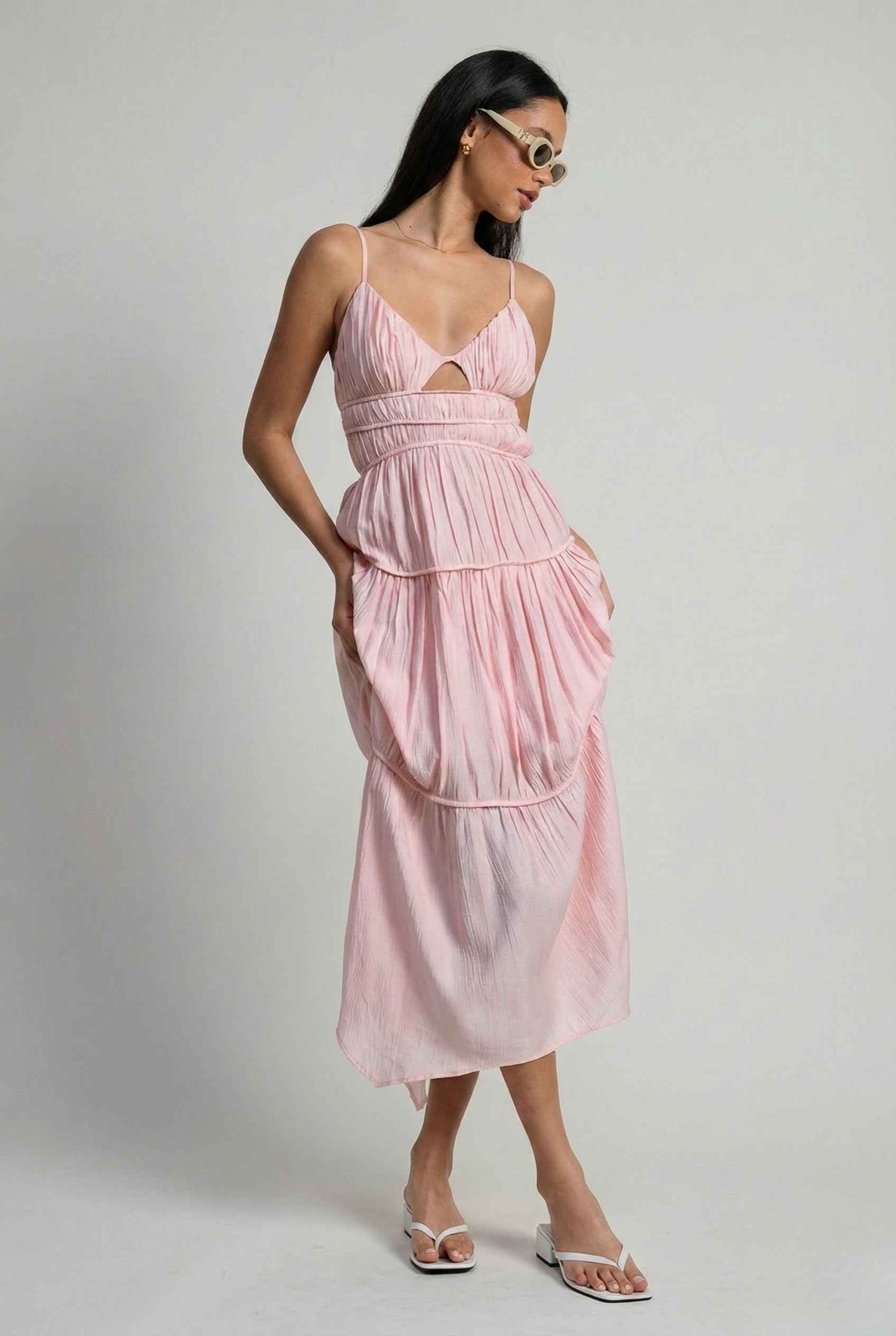 Woman wearing a Aria Maxi Pink Tiered Cutout Dress against a plain background