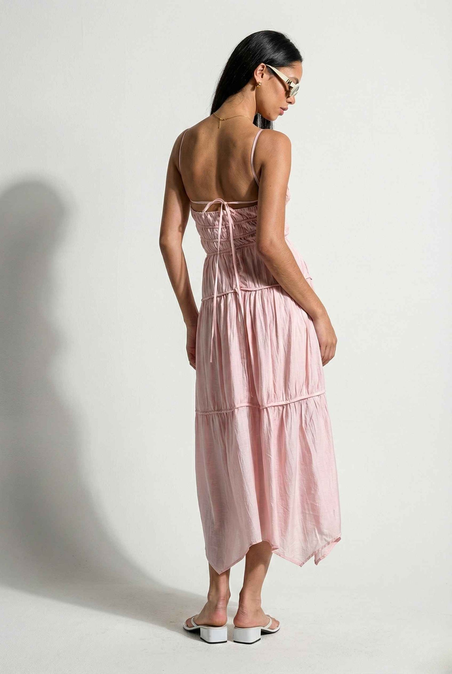 Woman wearing a Aria Maxi Pink Tiered Cutout Dress against a white background