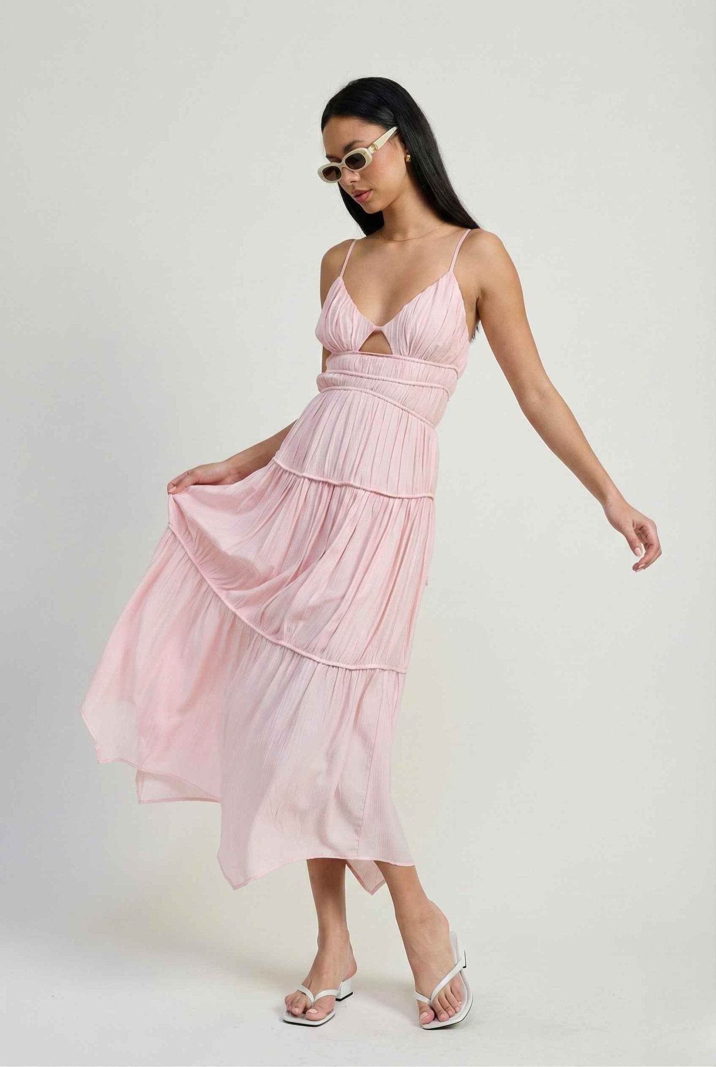 Woman wearing a Aria Maxi Pink Tiered Cutout Dress with thin straps on a white background