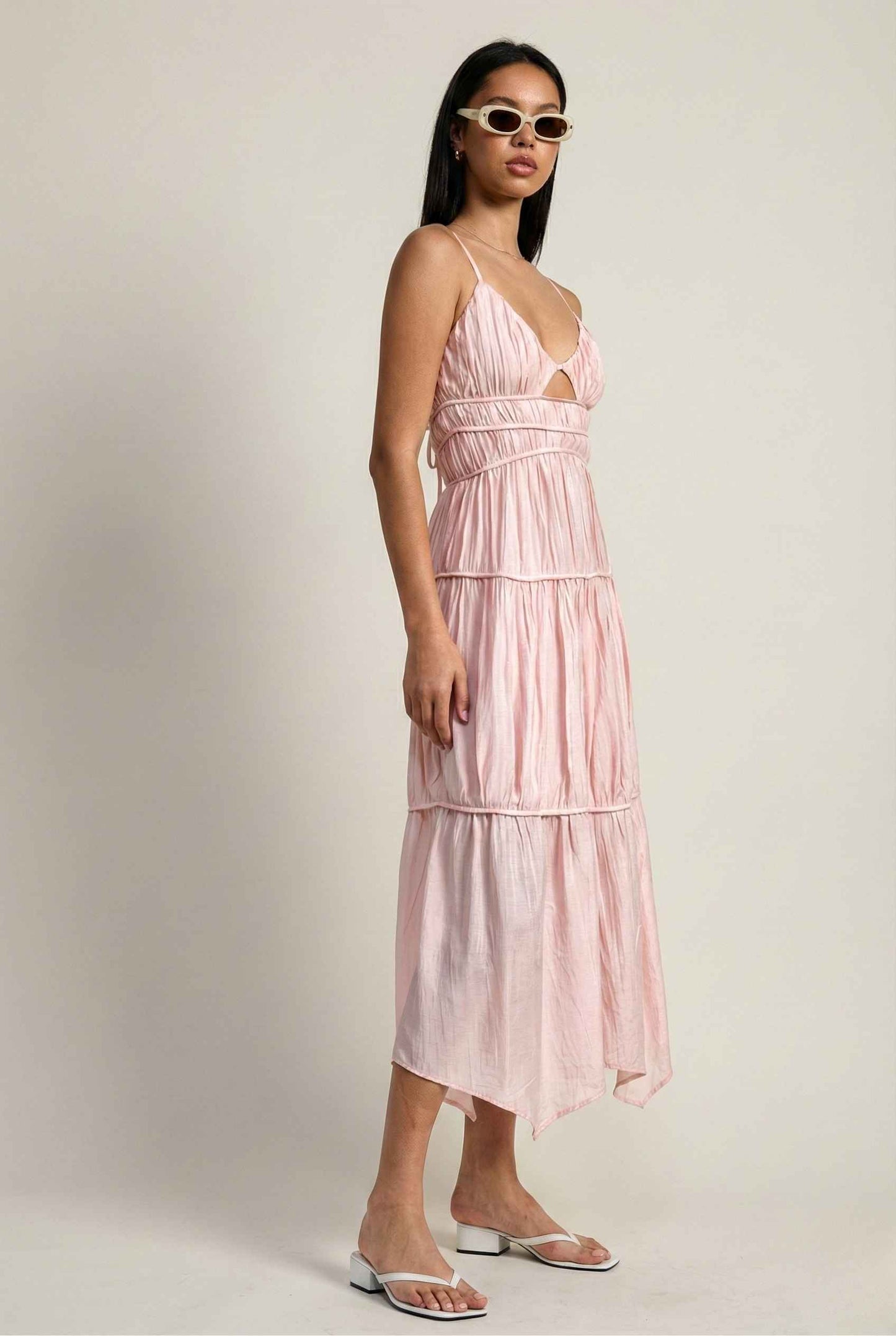Woman wearing a Aria Maxi Pink Tiered Cutout Dress with thin straps on a plain background