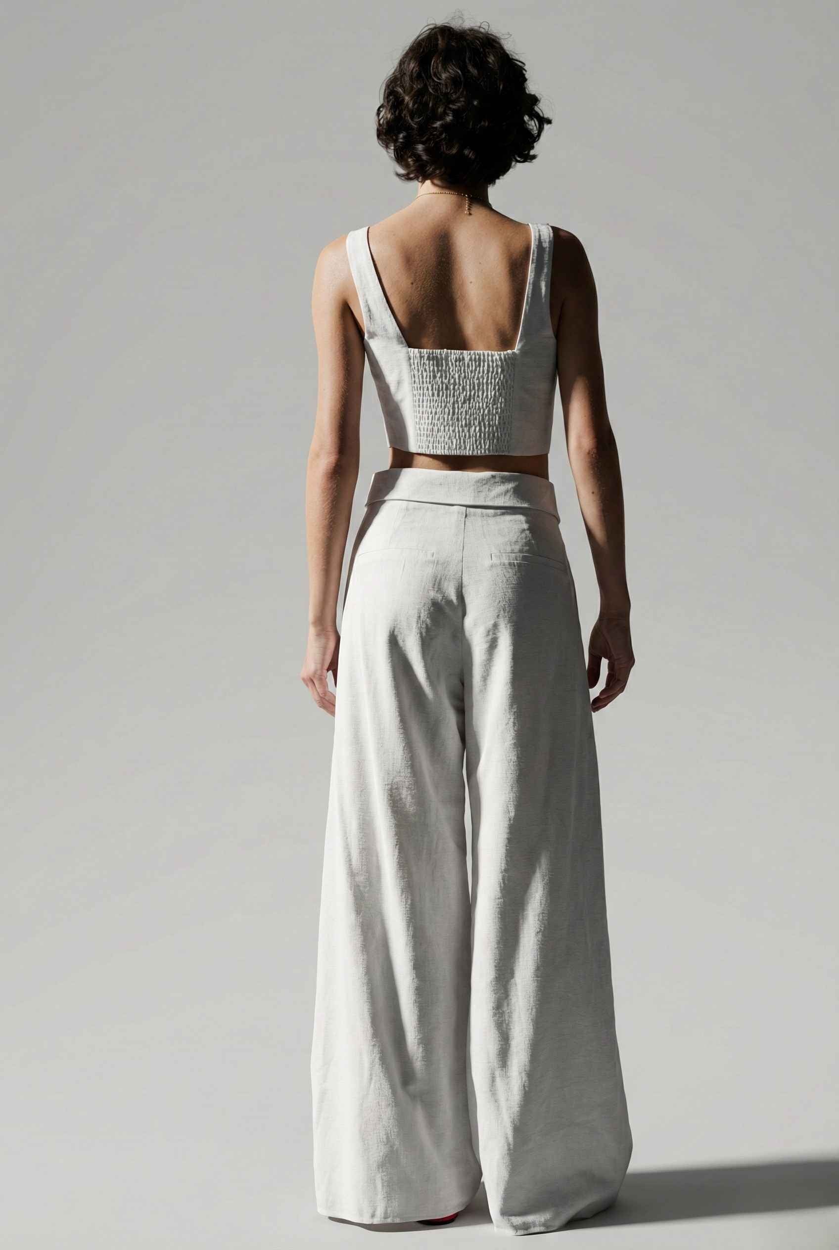 Woman wearing a Aria Top White Linen Blend Button Front Tie Crop Top.