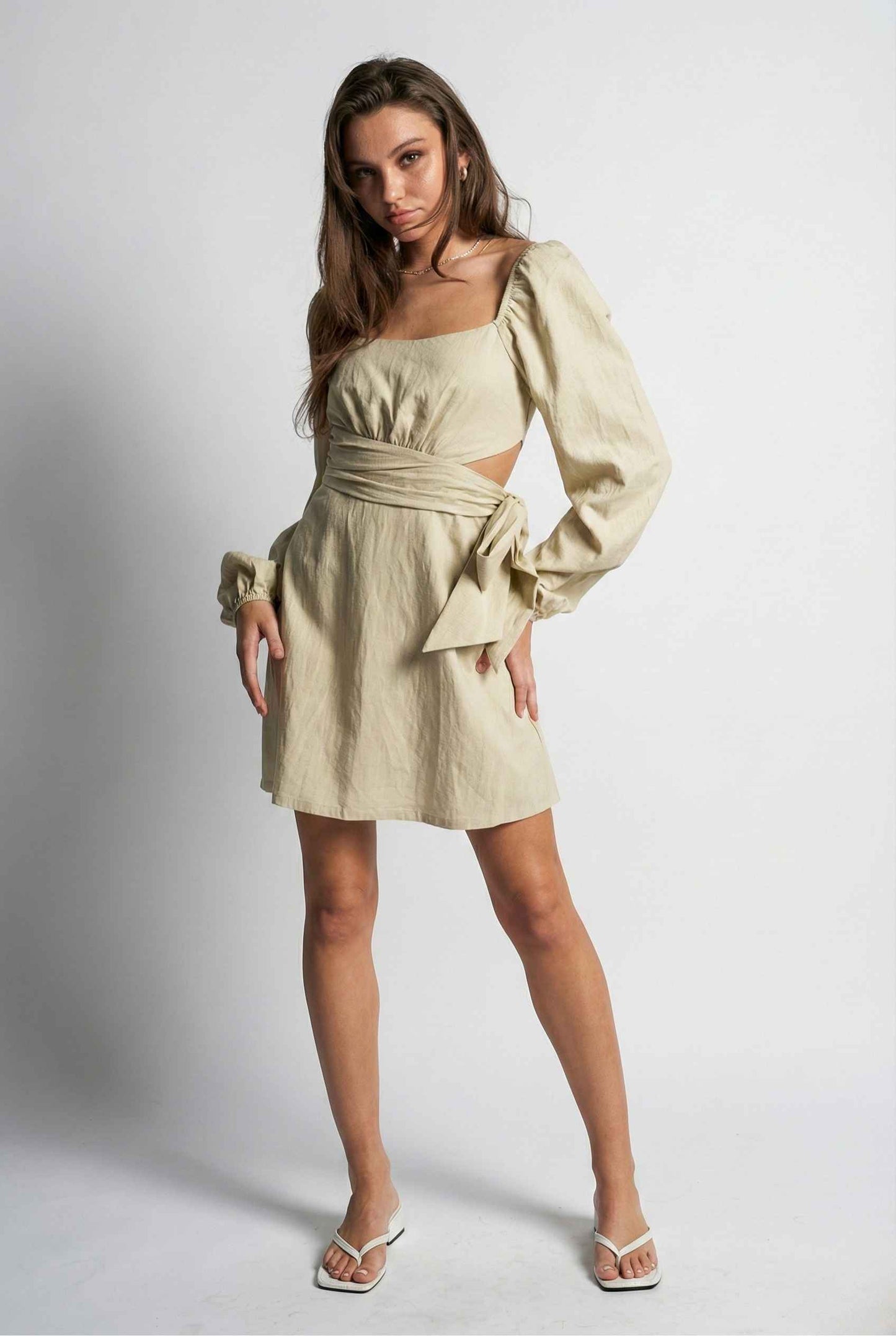 Woman wearing a Aurelia Mini Sage Long Sleeve Cutout Dress with long sleeves