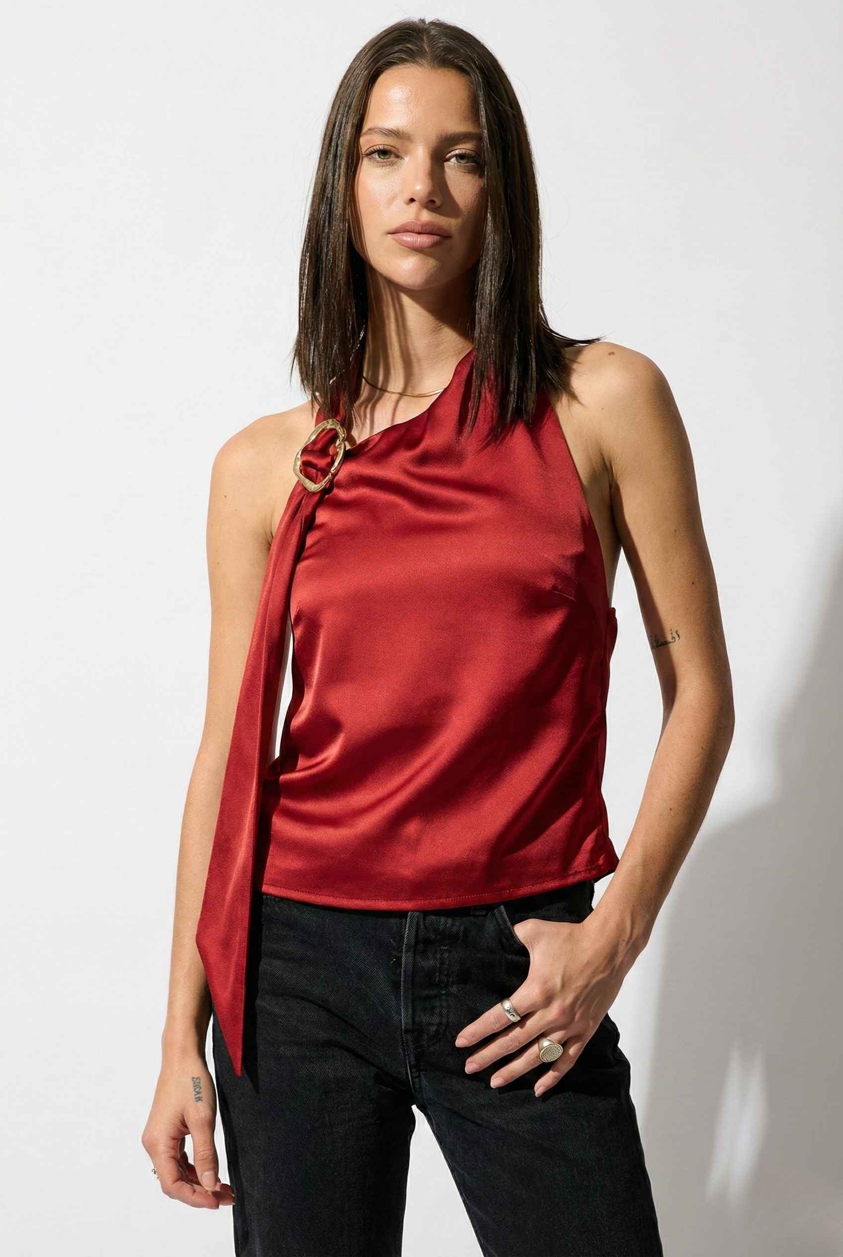 Woman wearing a Aurelia Top Burgundy Satin One-Shoulder Scarf Blouse with a unique design on a white background