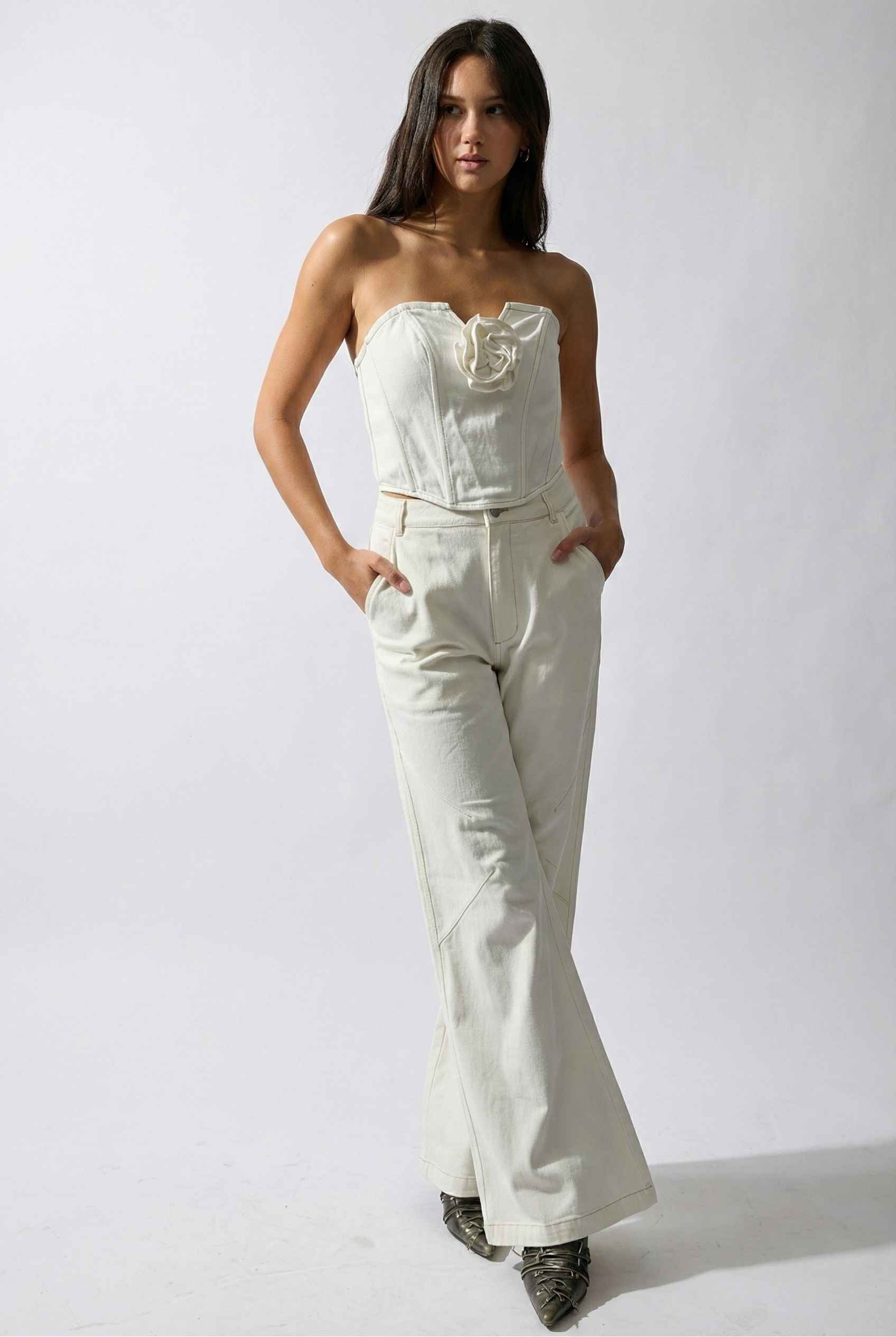 Model wearing Bianca Pants in Off White Cotton-Stretch Seamed Wide-Leg Trousers with matching corset top and heels against plain backdrop
