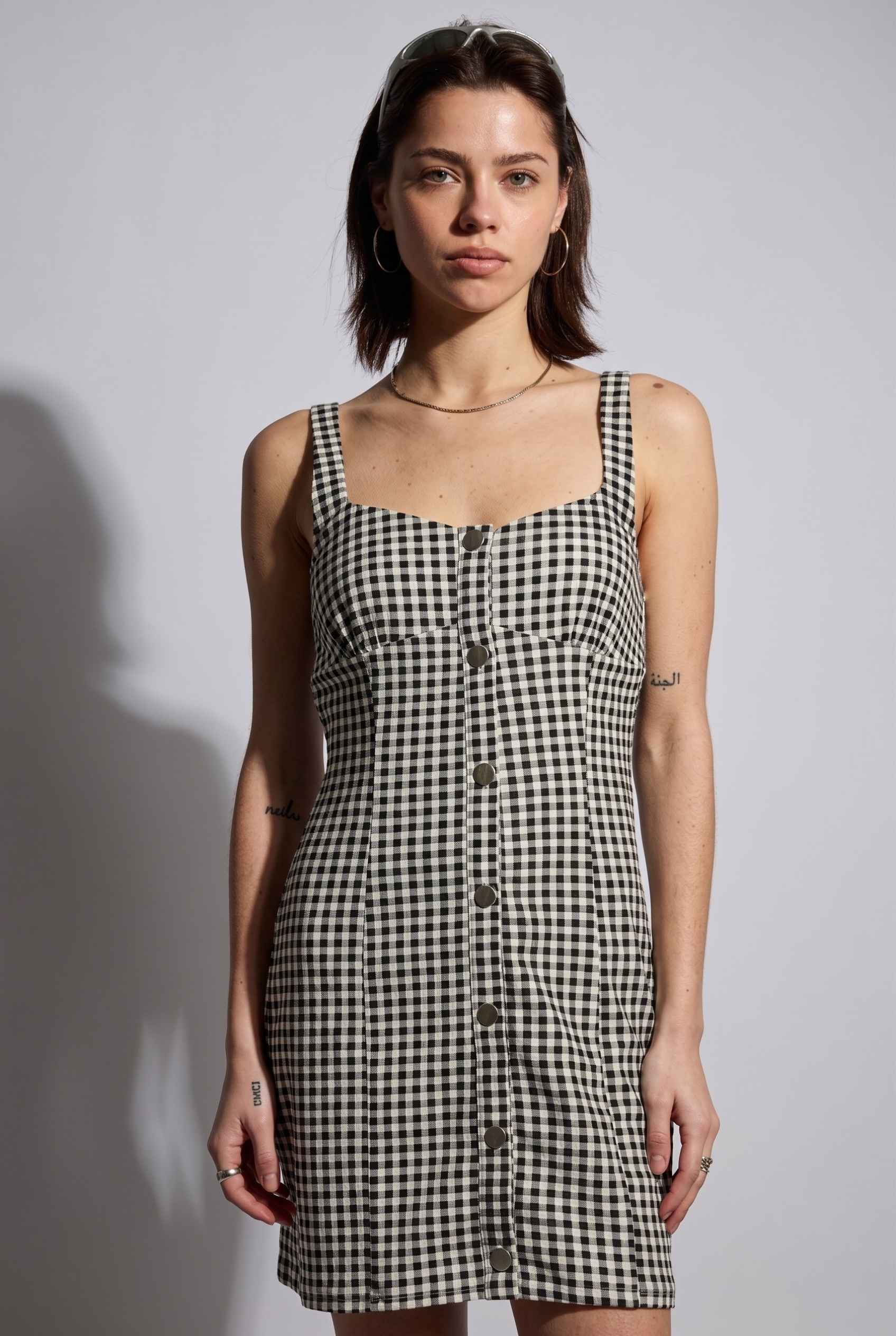 Model wearing Blair Button-Front Gingham Mini Dress Cotton Slip Dress in Black close up button front