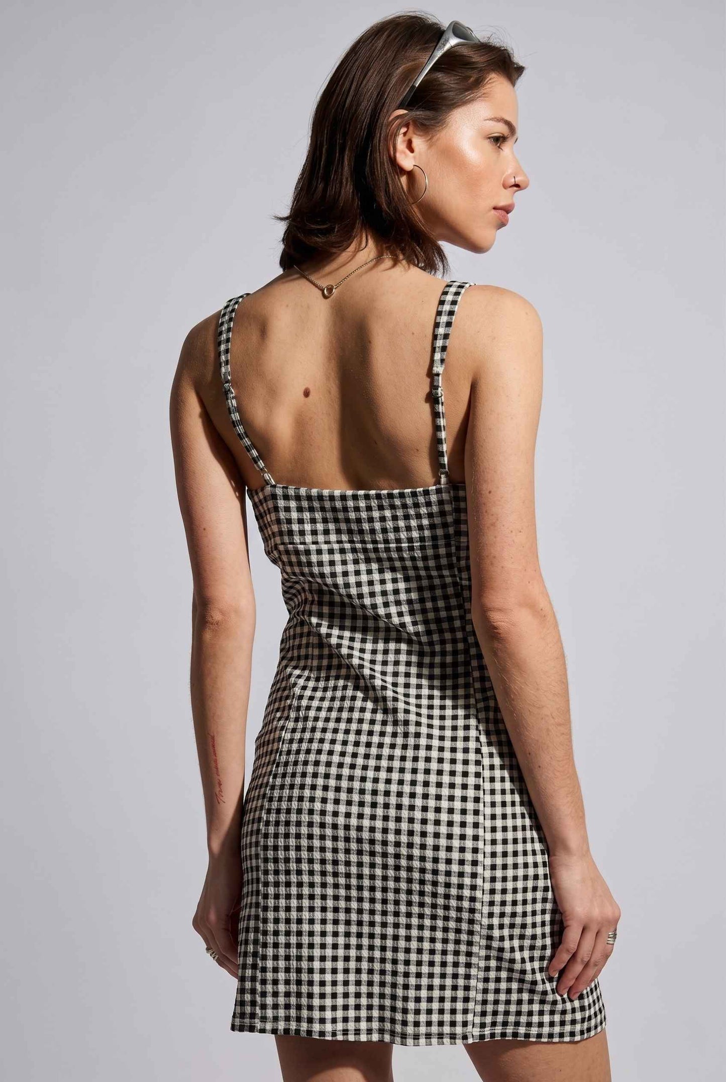 Model wearing Blair Button-Front Gingham Mini Dress Cotton Slip Dress in Black close up back detail spaghetti straps