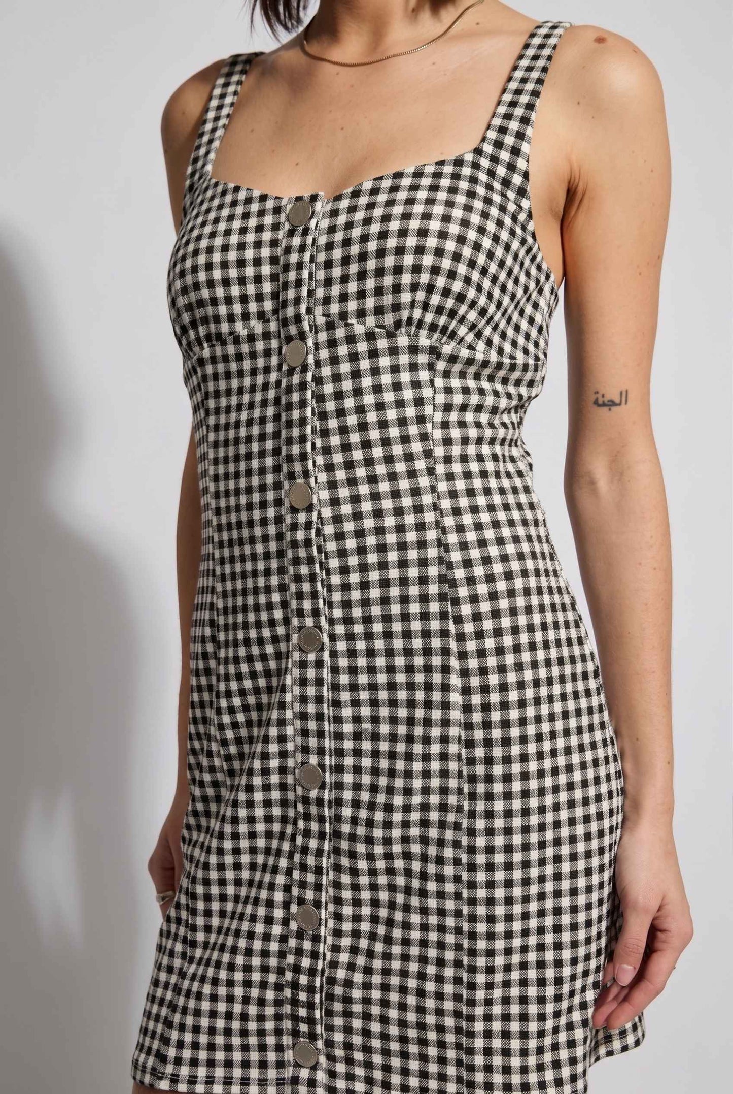 Model wearing Blair Button-Front Gingham Mini Dress Cotton Slip Dress in Black close up button detail front