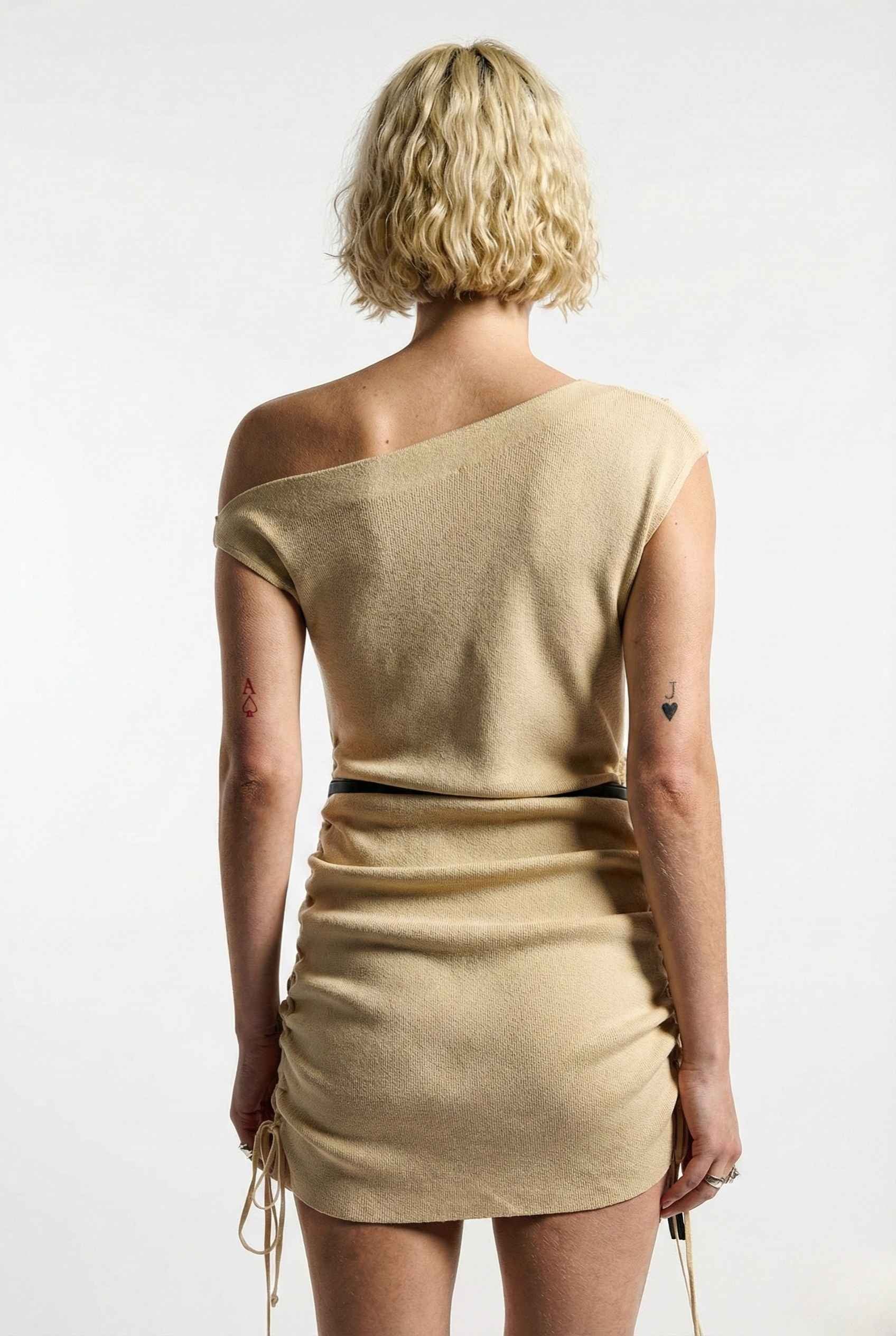 Woman wearing a Blaire Mini Cream Off-Shoulder Ruched Dress against a white background