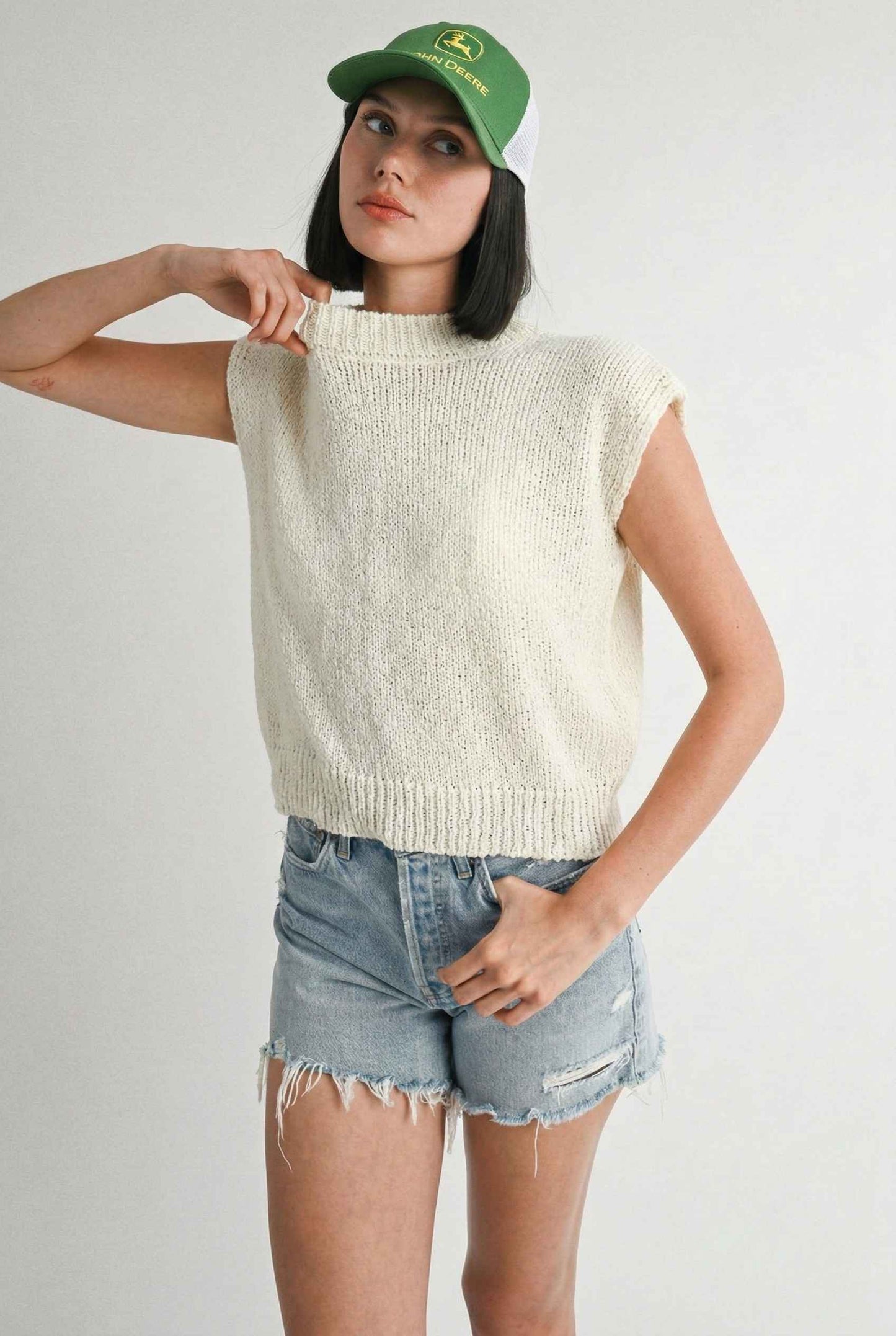 Model wearing Blaire Top in Off White Textured Knit Sleeveless Muscle Tee with denim shorts
